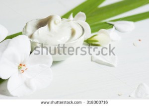 stock-photo-cosmetic-cream-with-white-flowers-on-bright-wooden-table-318300716